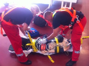 Our two clinicians preparing the patient for a stretcher winch